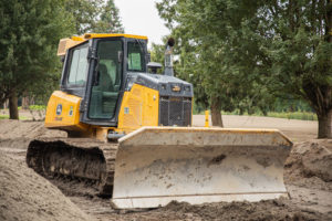 A crawler carrier shovelling dirt