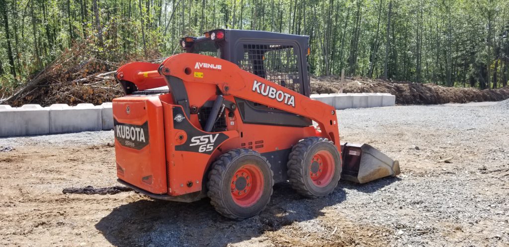 Rear angled view of Kubota skid steer on a property in British Columbia