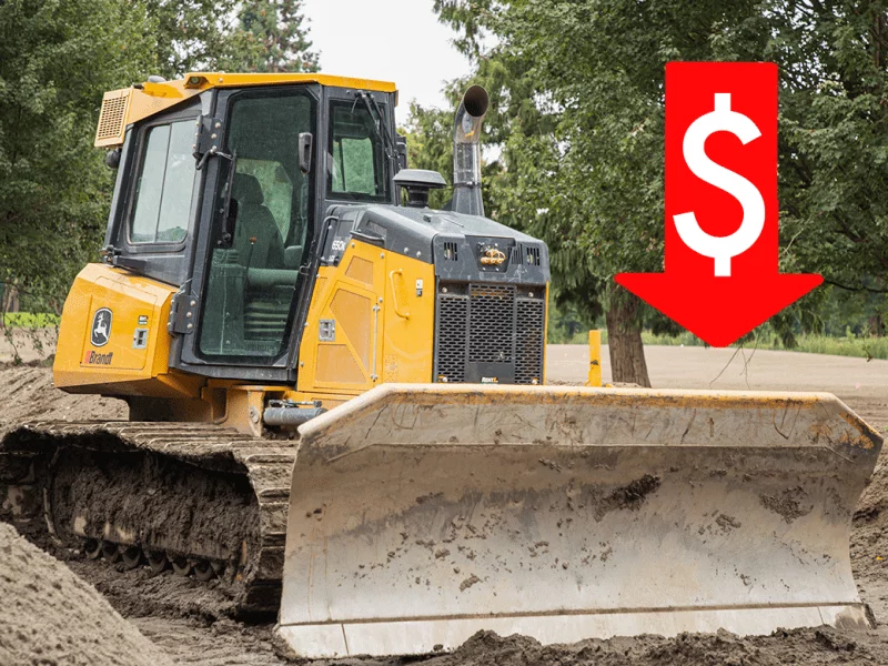 Crawler carrier shovelling dirt with a downwards arrow and dolar sign above it